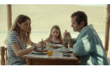 two girls and their father eating at the table